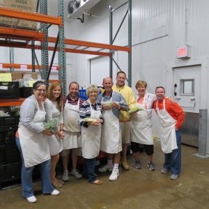 Shown left to right at the Food Bank warehouse are: Gail Coxe; Kelly Hoover; Phil Gagliardi; Carol Olver; Pete Hoover; Jerry Fahey; Beth Hoover; and Tim Curvan.