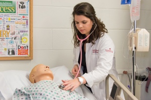 Montgomery County Community College student and Phi Theta Kappa Frank Lanza Memorial Scholarship recipient Kimberly Coffland works with a simulated mannequin in the College’s Nursing Lab. Photo by Sandi Yanisko.